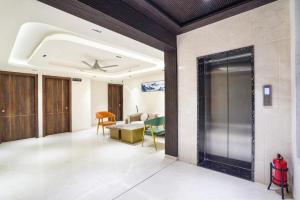 an office lobby with a sliding door and a living room at Raayara Suites in Bangalore