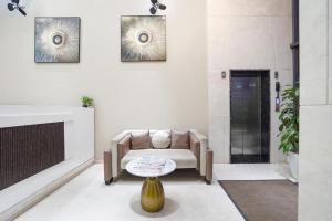 a living room with a chair and a table at Raayara Suites in Bangalore