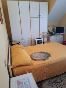 a bedroom with a bed with an orange blanket at VILLA flora e Riccardo in Fara San Martino
