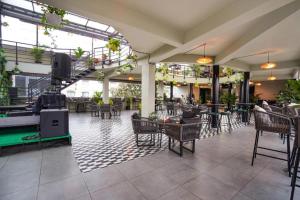 a restaurant with a pool table and tables and chairs at Raayara Suites in Bangalore