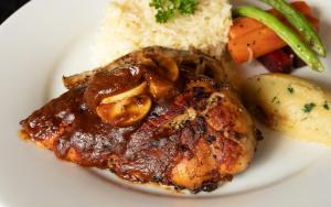 a plate of food with meat and rice and vegetables at Serenity Wellness in Kuruwita