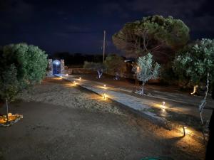 a row of lights in a park at night at Horizon House in Paros, Cyclades in Drios