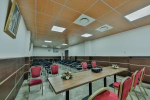 a conference room with tables and chairs in it at Hôtel Telemly - Chaine El Djazair in Alger