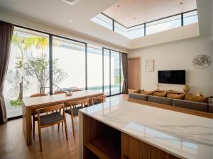 a living room with a couch and a table at Villa Kauri 3BR Pool Villa at Aileen Naithon in Ban Sakhu