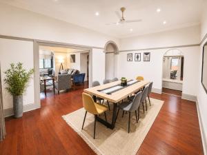 a dining room and living room with a table and chairs at Musgrave Escape - 3 bedroom home with tennis court in Durban