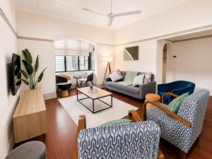 a living room with a couch and a table at Musgrave Escape - 3 bedroom home with tennis court in Durban