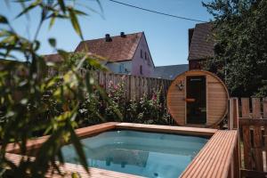 a swimming pool in a backyard with a wooden fence at Ferienhaus Steinhoff in Marsberg