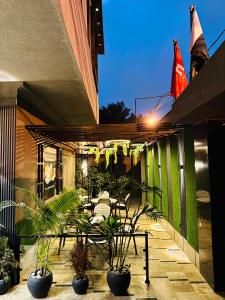 a patio with chairs and plants on a building at Holiday One Hotel & Suites - Gulshan-4 in Karachi
