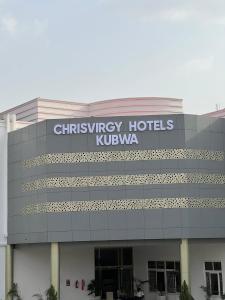 a building with a sign on the side of it at Chrisvirgy Hotels in Kubwa