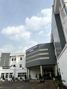 a building with a sign that reads hotel indonesia hall at Chrisvirgy Hotels in Kubwa
