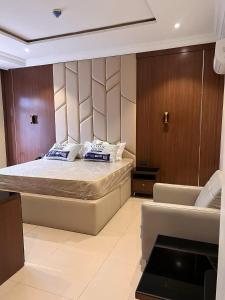 a bedroom with a bed and a couch at Chrisvirgy Hotels in Kubwa