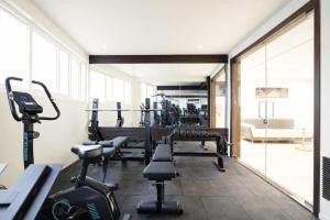 a gym with treadmills and machines in a room at Raayara Suites in Bangalore +15 photos