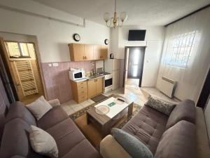 a living room with a couch and a table at Lav Apartments in Bihać