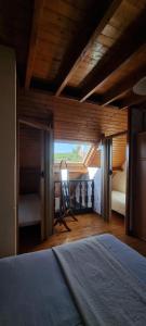 a bedroom with a bed and a room with a window at Duplex le Randonneur - Les Apparts du Sancy in Chastreix
