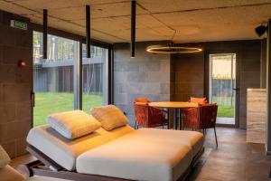 a bedroom with two beds and a table with chairs at ETERNA HOTEL & SPA by Fomich in Palyanytsya +57 photos