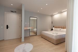 a bedroom with a large white bed and a mirror at Sirena Garden Resort in Tale +100 photos