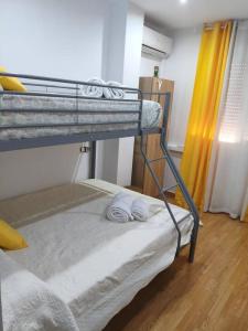 a bedroom with a bunk bed with towels on it at House Atarfe LINING1 in Atarfe