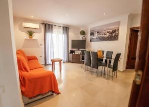a living room with a couch and a table with chairs at House Atarfe LINING1 in Atarfe