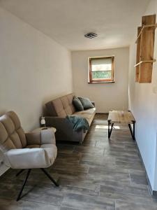 a living room with a couch and a table at Apartmán v klubu in Staré Sedlo