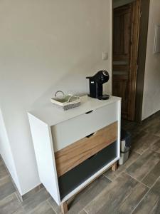 a white dresser with a coffee maker on top of it at Apartmán v klubu in Staré Sedlo