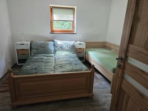 a bedroom with two beds and a window at Apartmán v klubu in Staré Sedlo