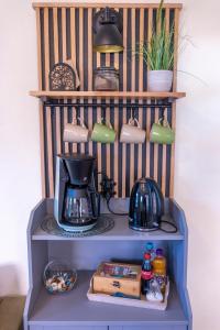 a shelf with a coffee maker and a tea kettle on it at Ferienwohnungen Villa Lütt in Bleckede +22 photos