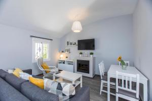 a living room with a couch and a table at Casa Alma Marbella in Marbella