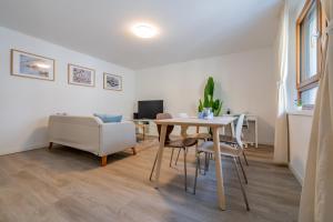 a living room with a table and chairs and a couch at Pure living Apartment in Zürich Oerlikon in Zurich