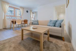 a living room with a couch and a table at Pure living Apartment in Zürich Oerlikon in Zurich