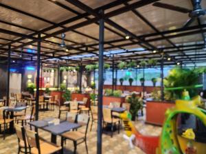 a dining area with tables and chairs at Hotel Suncity Residency in Kālundri