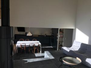 a living room with a table and chairs and a couch at LE REFUGE DE LUCE in Saint-Gervais-les-Bains