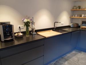 a kitchen with a sink and a counter with flowers on it at LE REFUGE DE LUCE in Saint-Gervais-les-Bains