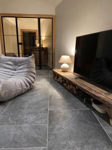 a living room with a large flat screen tv at LE REFUGE DE LUCE in Saint-Gervais-les-Bains