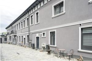 a building with chairs and tables in front of it at AFY STAYS Boutique Apartments in Bucharest