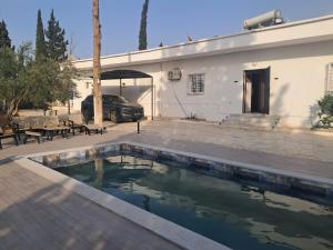 a house with a swimming pool next to a building at Domaine salma in Maherine