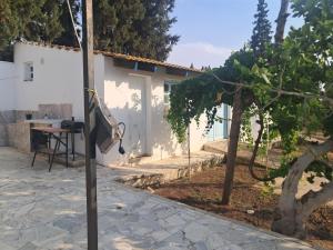 a television hanging from a pole next to a house at Domaine salma in Maherine +3 photos