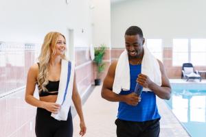 a man and a woman walking down a hallway at Rodd Crowbush Golf & Beach Resort in Morell