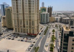 an aerial view of a city with tall buildings at TIDY Premium Hostel, Sharjah in Sharjah +3 photos