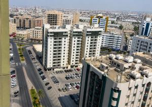 an aerial view of a city with tall buildings at TIDY Premium Hostel, Sharjah in Sharjah