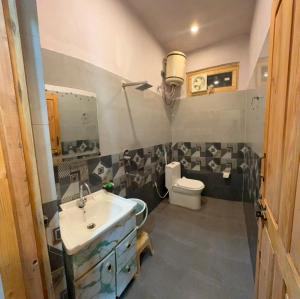 a bathroom with a sink and a toilet at Harshil wood stay in Harsil