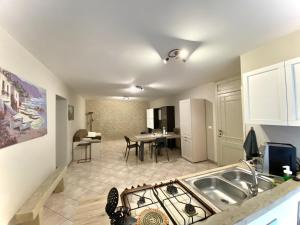 a kitchen and living room with a sink and a table at La Ginestra in Corleone +6 photos