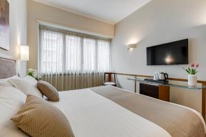 a hotel room with a bed and a flat screen tv at Best Western Hotel Piccadilly in Rome +27 photos