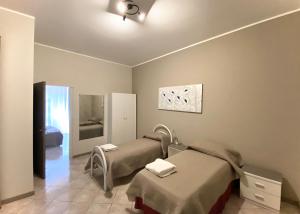 a hospital room with two beds and a mirror at La Ginestra in Corleone