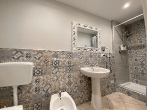 a bathroom with a sink and a toilet and a mirror at La Ginestra in Corleone