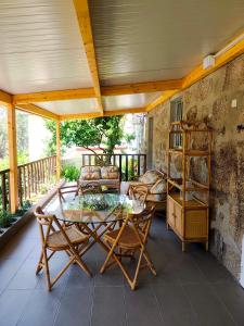 a screened in porch with a table and chairs at Quinta Cunha in São Pedro do Sul