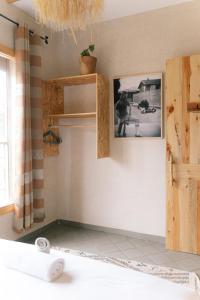 a room with a door and a picture on the wall at The Lodge - Boutique Hotel and Creative Residency in Tamraght Ouzdar +131 photos