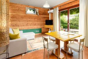 a living room with a table and a couch at Ca'Luna Guest House in Mondovì