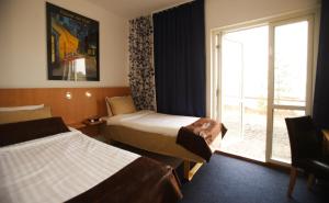 Postel nebo postele na pokoji v ubytování Hotell Höga Kusten