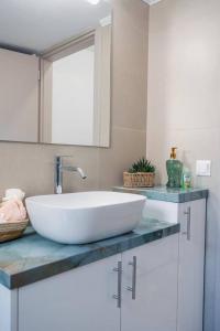 a bathroom with a large white sink on a counter at Vickys Apartment Diakopto in Diakopto