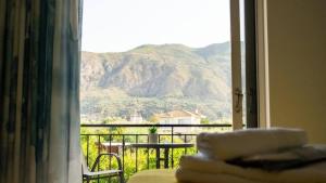 a room with a window with a view of a mountain at Vickys Apartment Diakopto in Diakopto